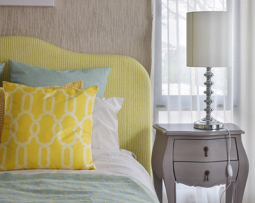 pattern-pillows-on-classic-style-bed-and-reading-lamp